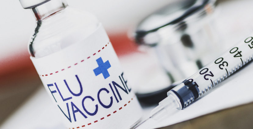 Flu vaccine with syringe and stethoscope